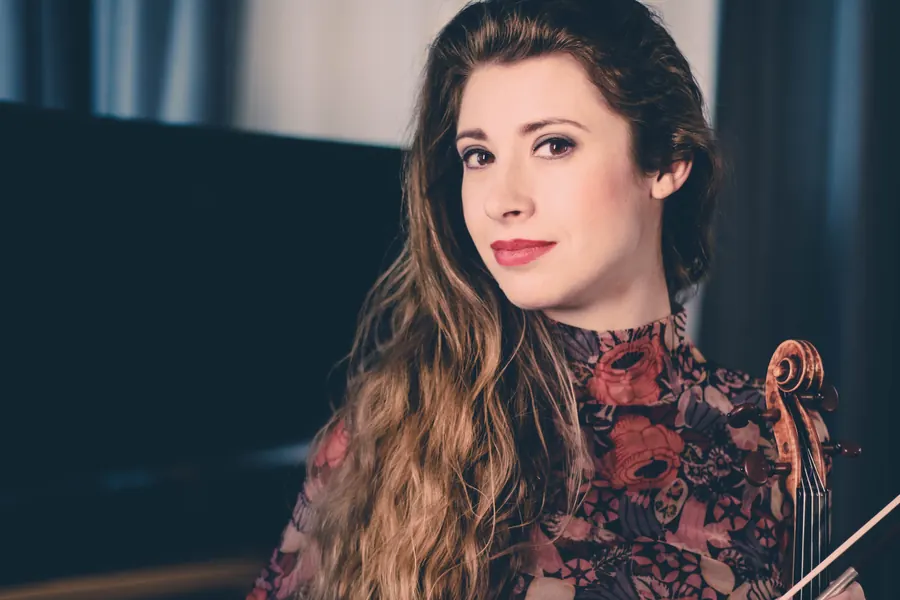 Floral blouse, violin scroll at her shoulder, deep blue interior
