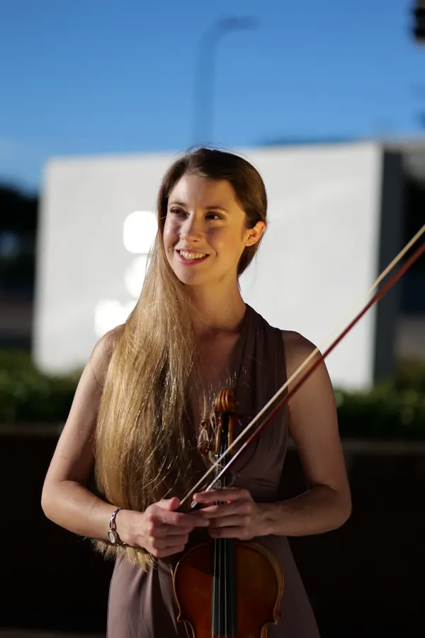 Golden-hour portrait in mauve gown with violin and bow — photo by Cicely Parnas