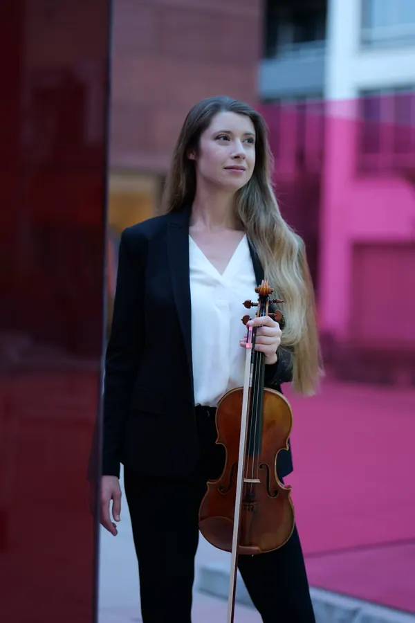 Full-length with violin, reflected in red glass — photo by Cicely Parnas