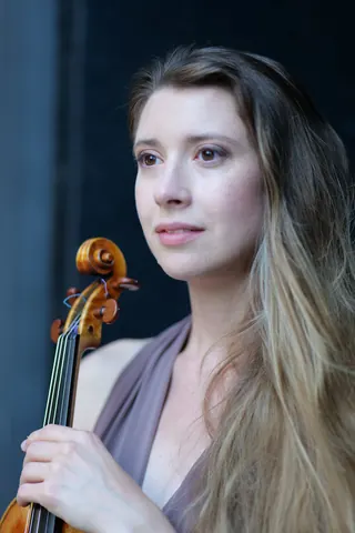 With her violin scroll